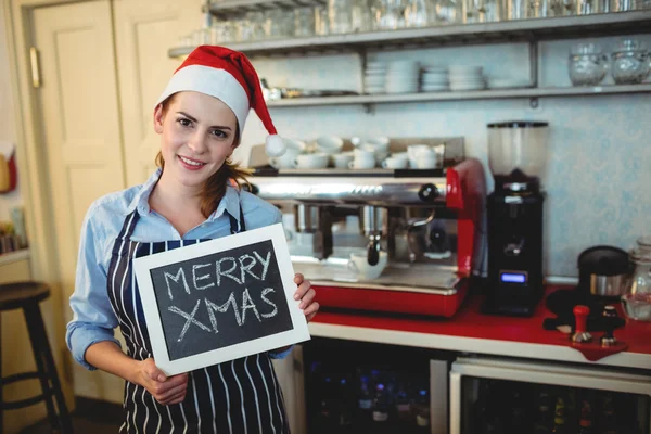 Barista tenuta segno di Natale al caffè — Foto Stock