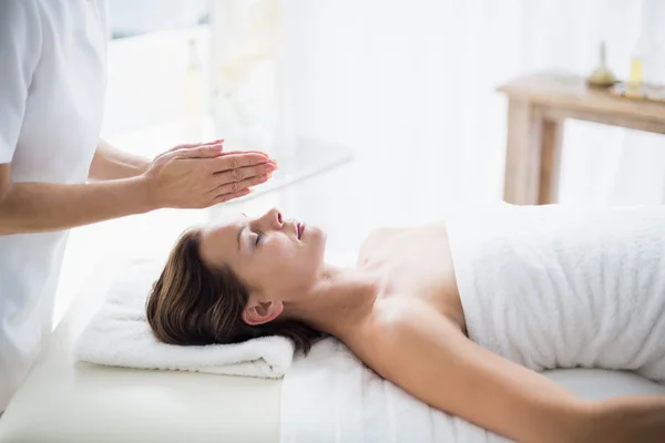 Therapist performing reiki on woman Royalty Free Stock Images