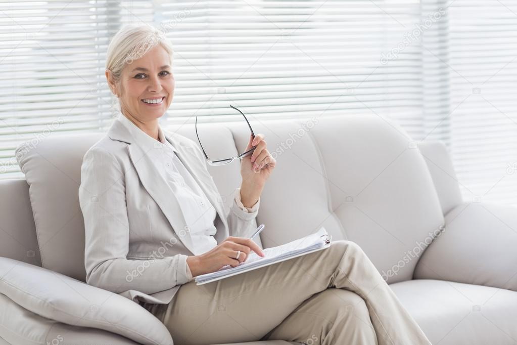 Happy therapist in office Stock Photo by ©Wavebreakmedia 114923704