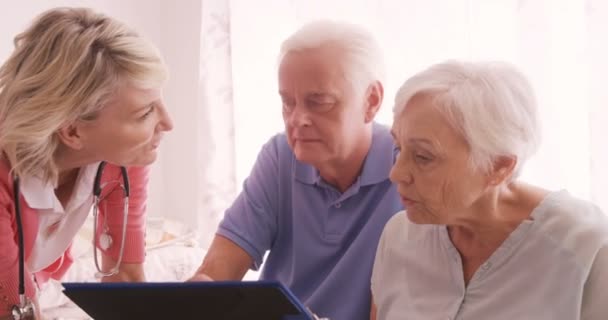 Médico consultoria para um casal de idosos — Vídeo de Stock