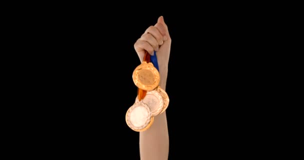 Hands throwing some medals — Stock Video