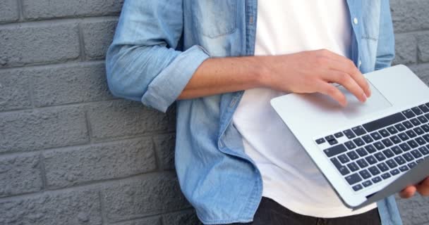 Fashionable man using laptop — Stock Video