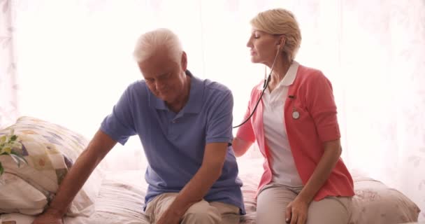 Médecin vérifiant un homme âgé avec stéthoscope — Video