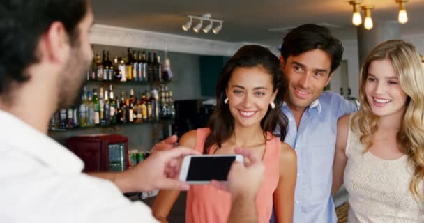 Man fotograferen zijn vrienden met smartphone — Stockvideo