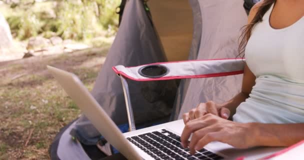 Kobieta za pomocą laptopa poza namiotem — Wideo stockowe