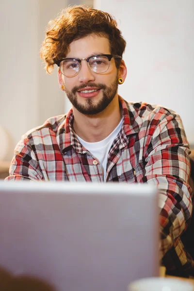 Portrait of graphic designer working on laptop