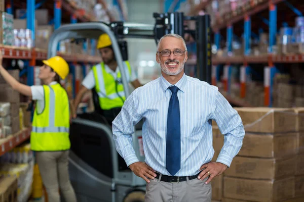 Portrait of manager is smiling and posing with hands on hips — Stock Photo, Image