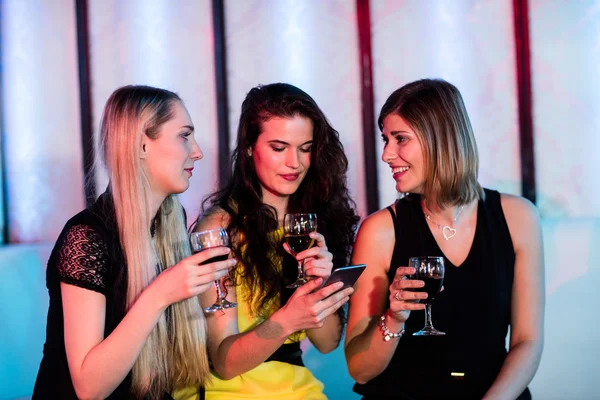 Friends interacting each other while having wine — Stock Photo, Image