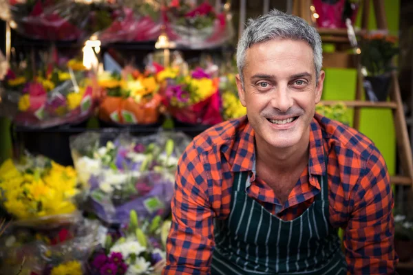Smiling male florist at flower shop
