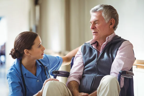 Nurse taking care of sad senior man — Stock Photo, Image