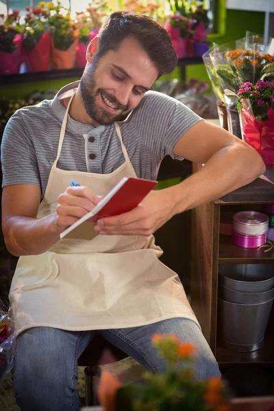 Floristería masculina observando orden en lácteos — Foto de Stock