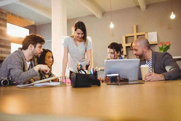 Grafica femminile che discute con i colleghi — Foto Stock