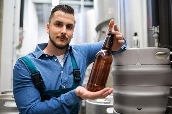 Cervejaria testando garrafa de cerveja — Fotografia de Stock