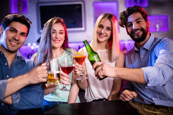 Friends toasting at bar counter in bar — Stock Photo, Image