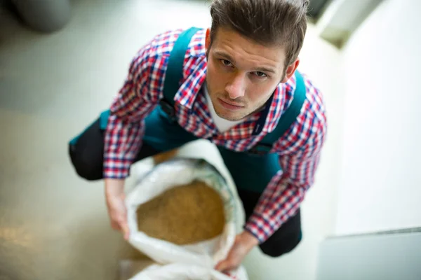 Brewer with sack of grains — Stock Photo, Image