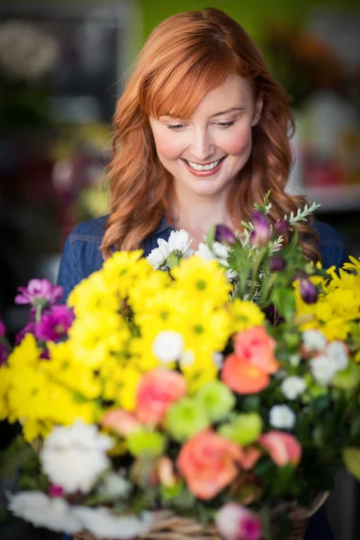 Female florist standing and smiling Stock Image