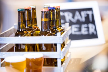 Close-up of beer bottles in crate clipart