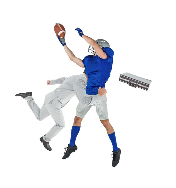 Businessman tackling football player — Stock Photo, Image