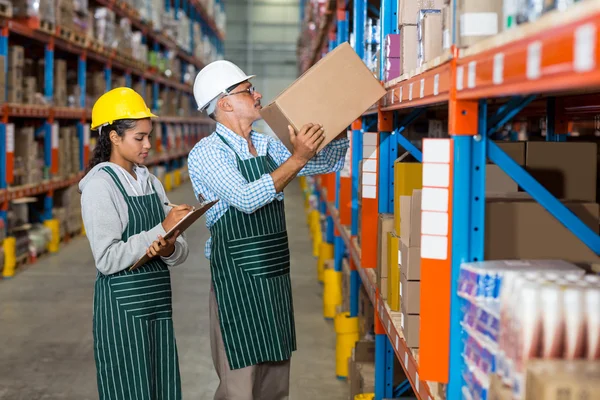 Workers colleague carrying and organizing box — Stock Photo, Image