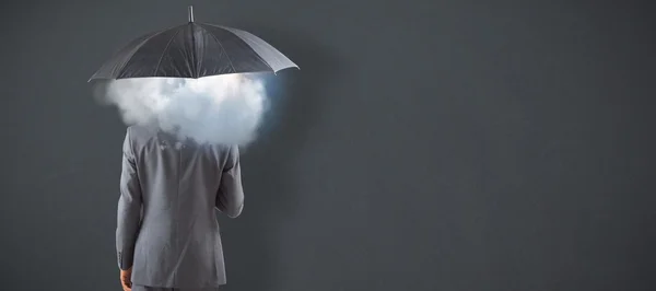 Бизнесмен, стоящий под зонтом — стоковое фото