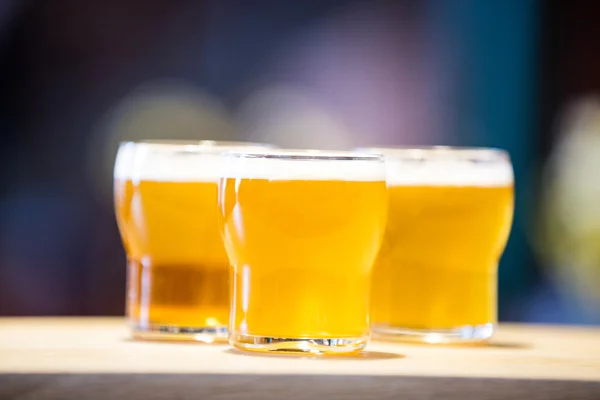 Три бокала пива на барной стойке — стоковое фото