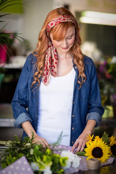 Femmina fiorista avvolgente bouquet di fiori — Foto Stock