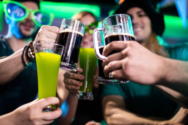 Friends toasting beer mugs and drink glasses — Stock Photo, Image