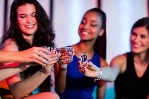 Friends toasting tequila shot glasses — Stock Photo, Image