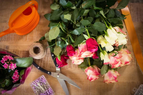 Bouquet of flower material on a wooden worktop — Stock Photo, Image