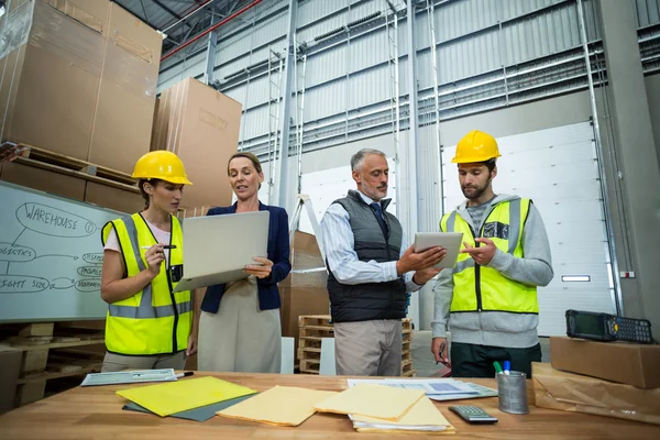 Warehouse team working on laptop and digital tablet — Stock Photo, Image