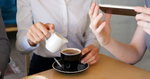 Mujeres mostrando teléfono a hombre de negocios — Vídeos de Stock