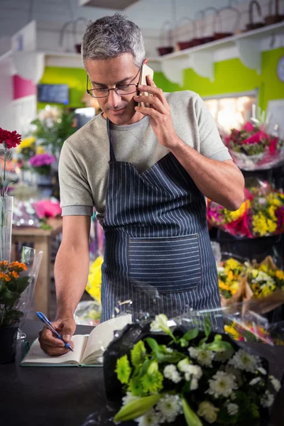 点菜的移动电话上的男性花店 — 图库照片