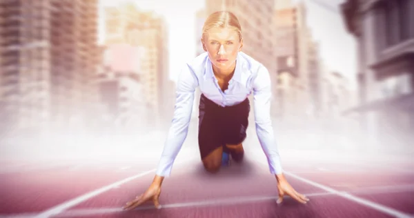 Businesswoman in starting blocks — Stock Photo, Image