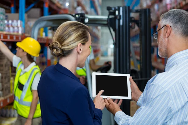 Rear view of business people are looking a tablet — Stock Photo, Image