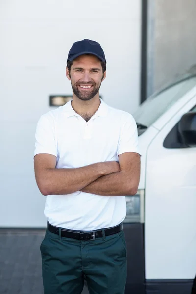 Portrait of delivery man is posing with crossed arms — Stock Photo, Image