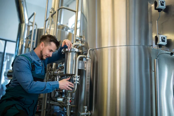 Brewer checking pressure at brewery — Stock Photo, Image