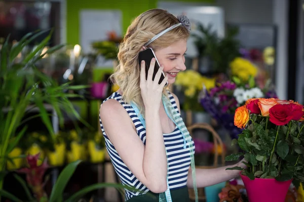 Florista feminina falando no telefone móvel — Fotografia de Stock