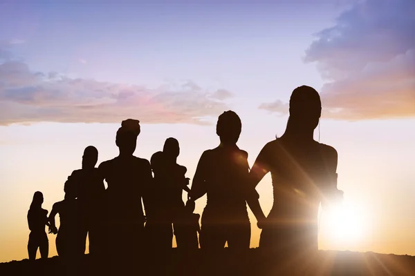 Running silhouettes against clouds — Stock Photo, Image