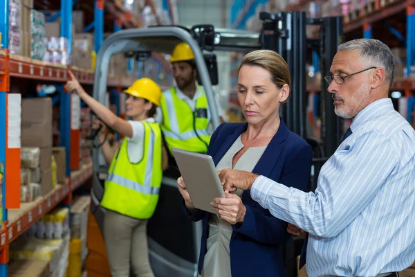 Serious managers are looking a tablet — Stock Photo, Image