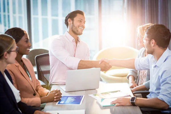 Coworker shaking hands with a colleague — Stock Photo, Image