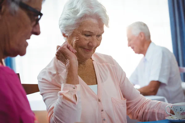 Senior smiling woman with a cup of coffee — Stock Photo, Image