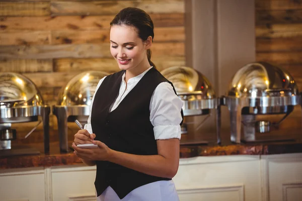 Waitress taking order on a notebook — Stock Photo, Image