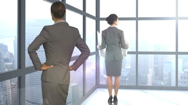 Businesswomen looking away by window — Stock Video