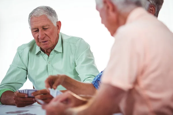 Smiling seniors people playing cards — Stock Photo, Image