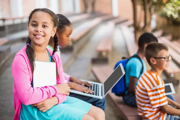 Kinder sitzen auf Bank und benutzen Laptop — Stockfoto