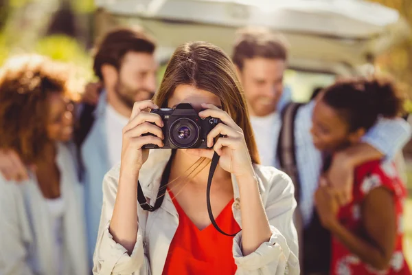 Woman clicking a photo from camera in park — Stock Photo, Image