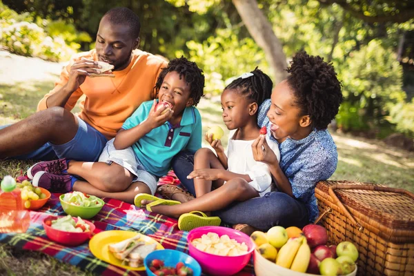 Happy family eating together — Stock Photo, Image