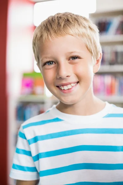 Portrait of happy schoolboy in library — Stock Photo, Image