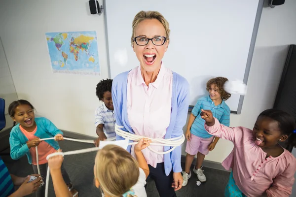 Students tying the teacher up — Stock Photo, Image