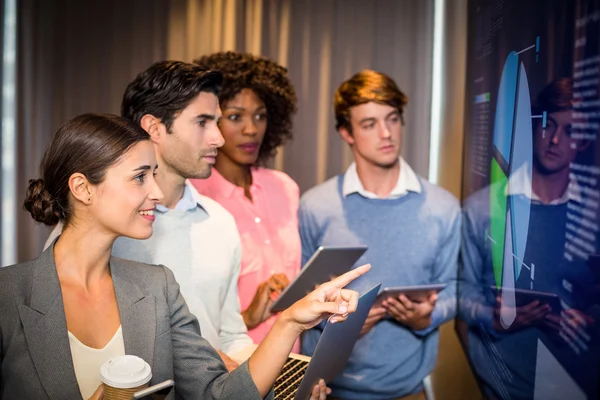 Business people looking at a graph in the conference room — Stock Photo, Image